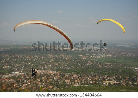 two para-glider flying over the city