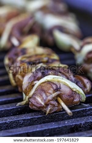 tasty meat and vegetables on wooden sticks