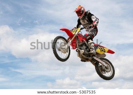 Red motocross bike jumping