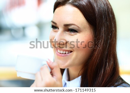 Closeup portrait of businesswoman drinking coffee in office cafe
