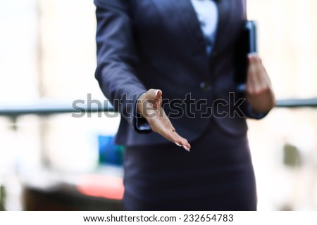 Businesswomans hand reaching out for handshake