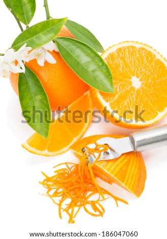 Orange fruit with leaves and blossom, orange zest with zester isolated on a white background, top view.