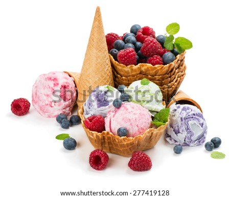 Different ice cream and berries in a wafer cones and bowl isolated on white background