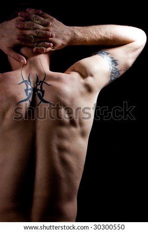 stock photo low key of man back with tattoo