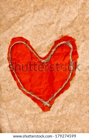 Red heart on a piece of old paper