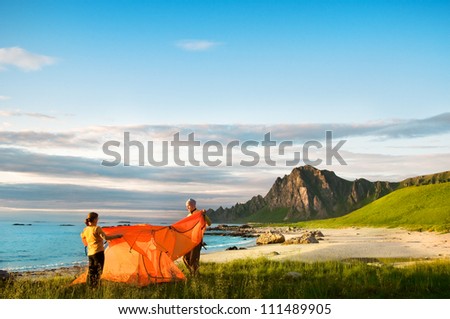 couple with tent near seaside