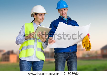 Foreman and student with blueprints at construction site