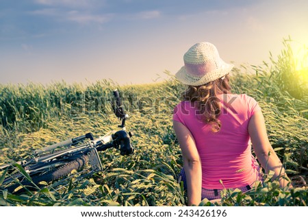 woman with bicycle countryside in summer