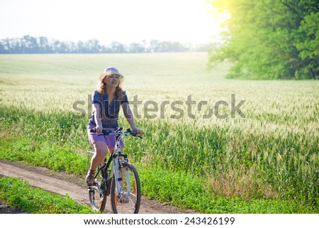 woman with bicycle countryside in summer