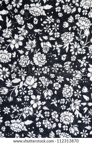 Cloth background with a floral pattern, white on black
