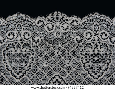 white lace with a floral pattern on a black background