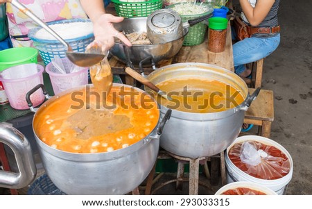 Thailand street food spicy chicken soup boiling in the big pot eat together with rice noodle, This menu name is \