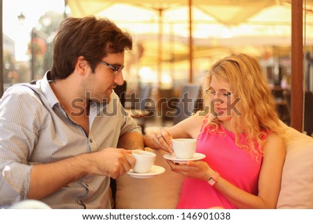 Close up of a young couple enjoying in cafe having coffee.
