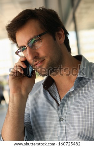 Portrait of a handsome man having phone conversation
