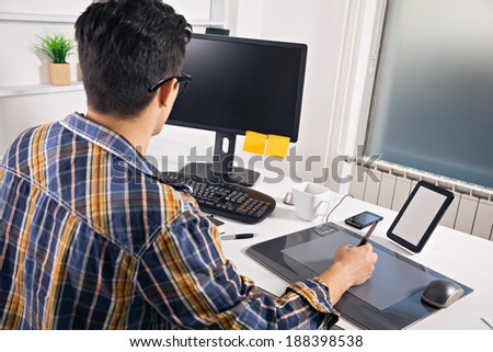 Young graphic designer working in office