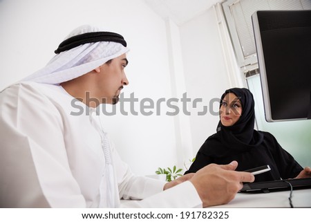 Arabic Business Couple Working In Office Using Tablet And Computer