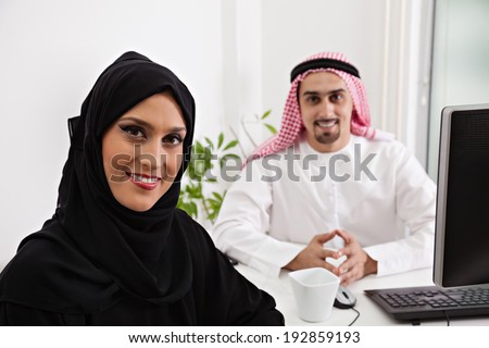 Arabic business couple working. Focus is on the woman.