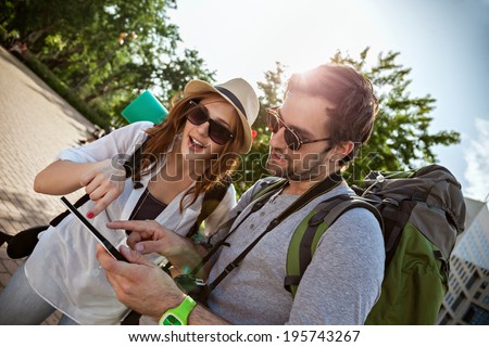 Two Young Tourists Sightseeing City Using Digital Tablet