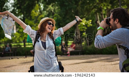 Happy Tourist Couple Enjoying City And Taking Photo
