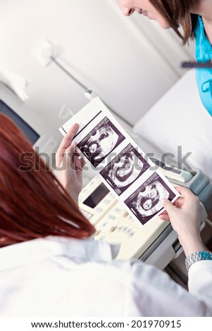 Pregnant Woman And Doctor Looking An Ultrasound Scan