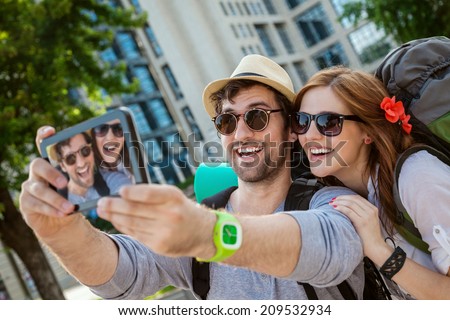 Two Young Tourists Taking Selfie Using Digital Tablet