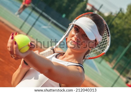 Female Getting Ready To Serve On A Tennis Court