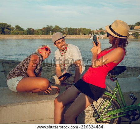 Three Hipster Friends Taking A Photo Near River