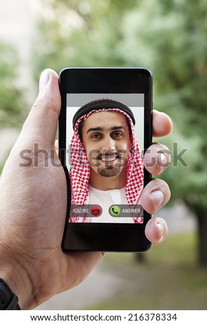 Close Up To Human Hand Holding A Smart Phone With Ringing Phone Caller On A Screen