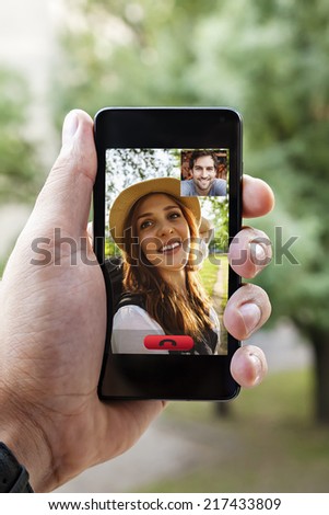 Close Up Of A Male Hand Holding A Smart Phone During A Video Call With His Girlfriend