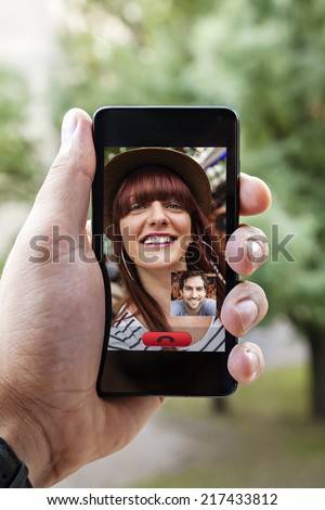 Close Up Of A Male Hand Holding A Smart Phone During A Video Call With His Girlfriend