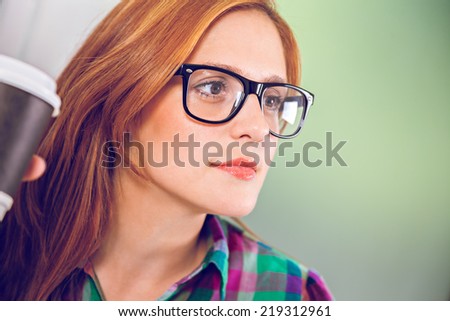 Young Female Graphic Designer Drinking Coffee At Work