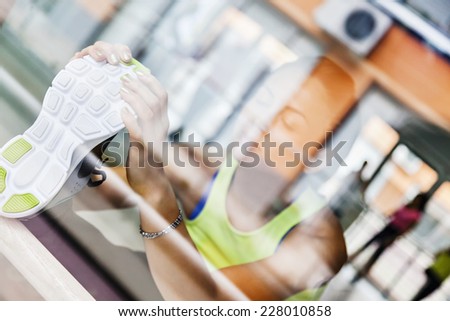 An Attractive Female Runner Stretching Before Workout