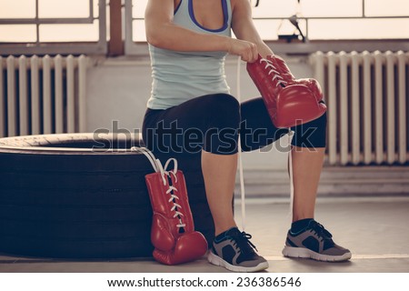 Female Boxer Binding Boxing Gloves And Preparing For Training