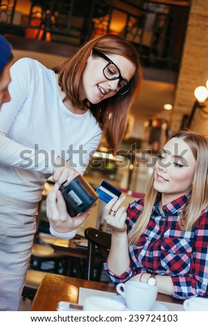 Beautiful Waitress Charging Customers Bill With A Credit Card Terminal