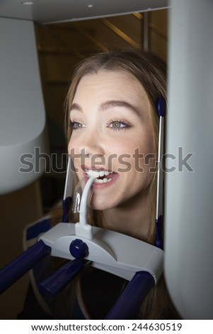 Female Patient Taking Panoramic Digital X-ray Of Teeth