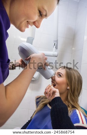 Young Dentist Taking Panoramic Digital X-ray Of A Patient`s Teeth