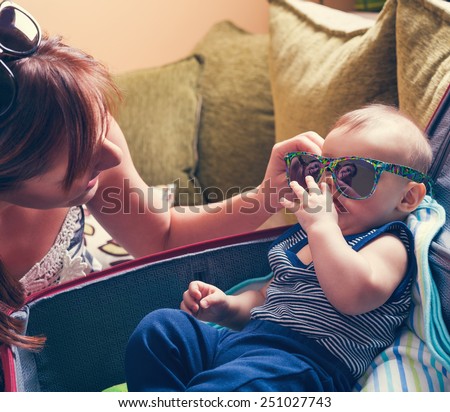 Adorable Baby Boy In Suitcase Trying On Sunglasses With His Mother And Getting Ready For Traveling