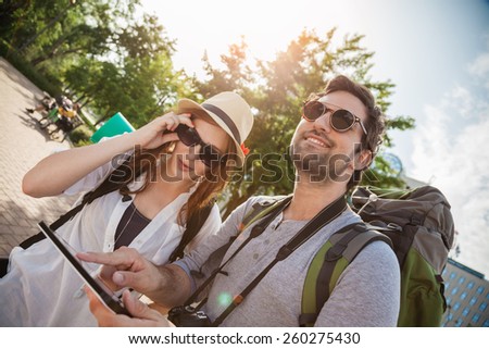 Tourist Couple Sightseeing City Browsing Map Using Digital Tablet