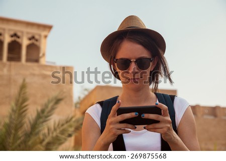 Young Tourist Woman Using Smart Phone And Enjoying Sightseeing Landmark