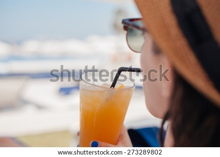 Close Up Of Young Female Drinking Fruit Cocktail And Enjoying Beautiful Day At The Beach