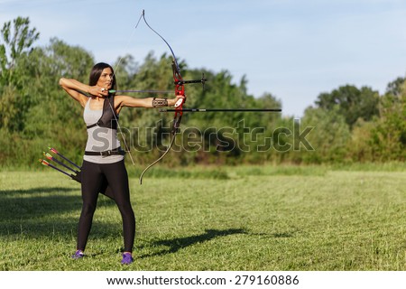 Attractive Female Practicing Archery At The Range