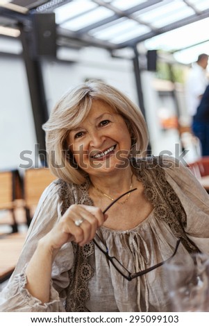 Portrait Of Smiling Mature Woman In Restaurant