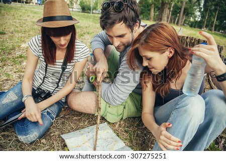 Group Of Friends In Nature Taking A Rest And Browsing Map