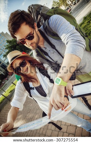 Tourist Couple In The City Browsing Map Using Digital Tablet