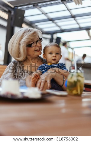 Grandmother With Her Adorable Grandson At Restaurant