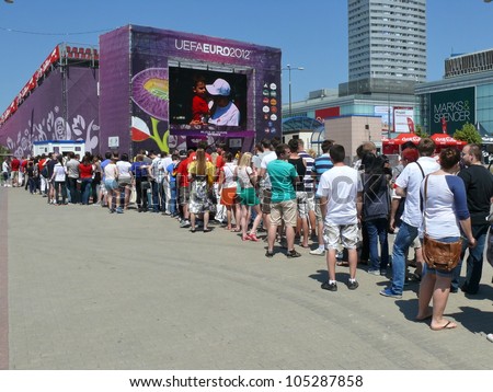 WARSAW, POLAND - JUNE 16: Polish football fans queuing for the entry to the Fan zone tribunes hours before UEFA EURO 2012 football match vs. Czech national team, June 16, 2012 in Warsaw, Poland