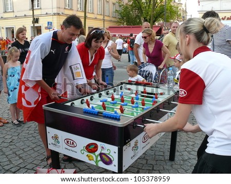 WARSAW, POLAND - JUNE 16: Polish football fans enjoying their time in Warsaw, playing outdoor table soccer before UEFA EURO 2012 football match vs. Czech team, June 16, 2012 in Warsaw, Poland