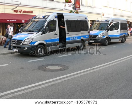 WARSAW, POLAND - JUNE 16: Polish policemen rushing to a riot that bursted on the street before UEFA EURO 2012 football match vs. Czech team, June 16, 2012 in Warsaw, Poland
