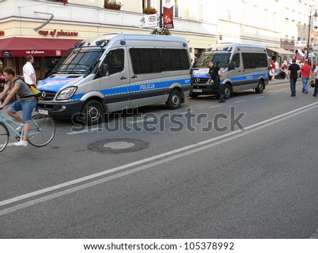WARSAW, POLAND - JUNE 16: Polish policemen rushing to a riot that bursted on the street before UEFA EURO 2012 football match vs. Czech team, June 16, 2012 in Warsaw, Poland