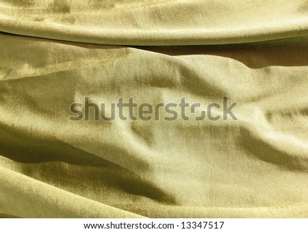 Creased gold, golden, satin fabric. For Christmas, bedroom, bed sheet, bed linens, bed cover, fashion, abstract, drapery, sexy textile background design. More textiles and background in my port.